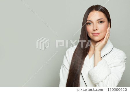 Charming model woman with sleek long shiny brown hair. Cosmetology, hair and skin care 120300620