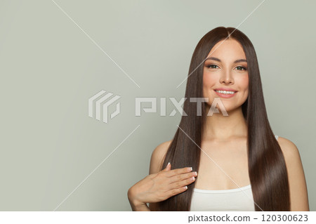 Smiling model woman with sleek long shiny brown hair. Cosmetology, hair and skin care 120300623