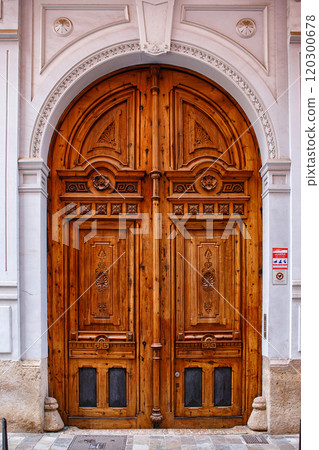 Wooden Entrance Doors With Ornate Carvings in an Urban Setting During the Daytime Wooden Entrance Doors With Ornate Carvings in an Urban Setting During the Daytime 120300678