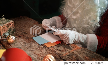 Santa Claus Is Reading The Children's First Christmas Letters On The Desk 120300749