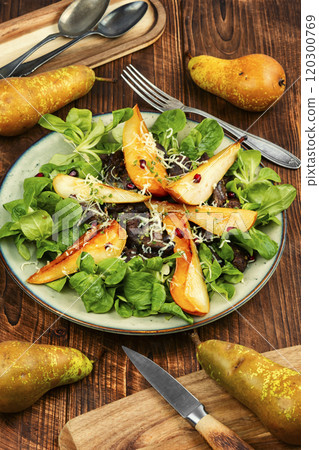 Salad with liver, caramelized pear in a plate. 120300769
