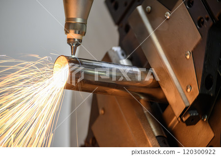 Close up scene the fiber laser cutting machine cut the stainless steel tube and sparkling light. 120300922