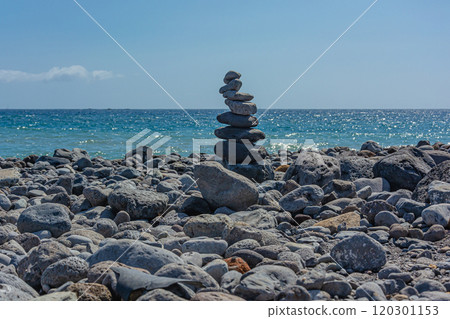 Seascape. Pyramid of stones on a rocky shore against the sea Seascape. Pyramid of stones on a rocky shore against the sea 120301153