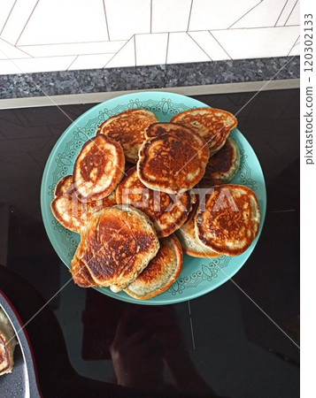 Freshly tasty stack of pancakes on the plate, maple syrup and blueberries isolated on a white background. Delicious homemade breakfast or lunch. Directly above 120302133