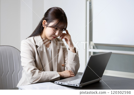 Woman worried about desk work 120302598