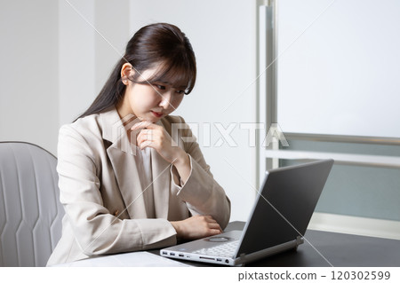 Woman worried about desk work 120302599