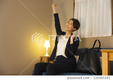 Business woman in the living room at night Business woman in the living room at night 120303101