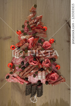 Christmas tree made of sausage on a background of a wooden wall Christmas tree made of sausage on a background of a wooden wall 120303915