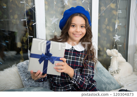 little child girl likes xmas present. Christmas. Kid enjoy the holiday. Happy new year. small happy girl at christmas. The morning before Xmas. New year holiday. Christmas together 120304873