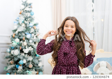 christmas family holiday. happy new year. Christmas shopping. Cute little child girl with xmas present. The morning before Xmas. waiting for santa. Winter. What a great surprise 120304874