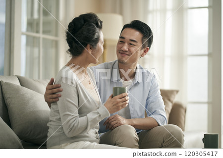asian adult son chatting with senior mother at home asian adult son chatting with senior mother at home 120305417