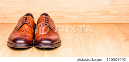 Elegant Brown Leather Shoes on Wood Background Elegant Brown Leather Shoes on Wood Background 120305692