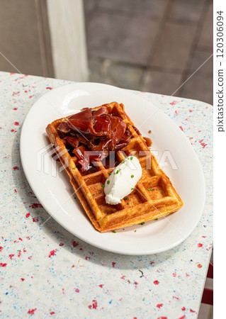 Portion of waffle with brisket and cream cheese 120306094