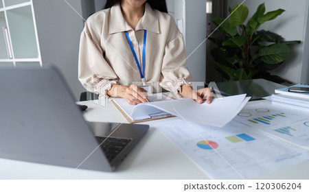 Professional Workspace with Documents and Laptop on Table for Business and Office Work in a Modern Setting Professional Workspace with Documents and Laptop on Table for Business and Office Work in a Modern Setting 120306204