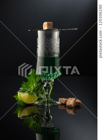 Glass of absinthe with ingredients on a black background. Glass of absinthe with ingredients on a black background. 120306280
