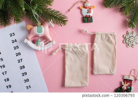 Christmas Advent calendar with gift velvet bags on a light pink background. 120306793