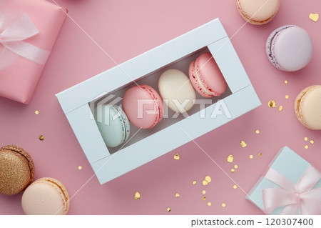 Colorful macarons in a white box with gifts and decorations on a pink background Colorful macarons in a white box with gifts and decorations on a pink background 120307400