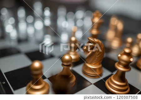 Chessboard with close up of chess game pieces Chessboard with close up of chess game pieces 120307508