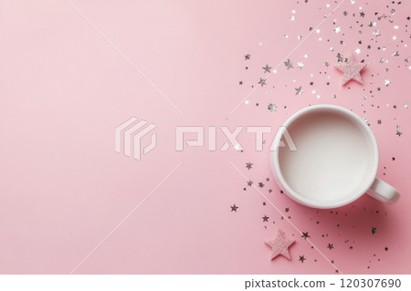 A cozy cup of milk surrounded by decorative stars on a pink background 120307690