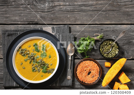 Pumpkin Red Lentil Soup in white bowl, top view Pumpkin Red Lentil Soup in white bowl, top view 120308409