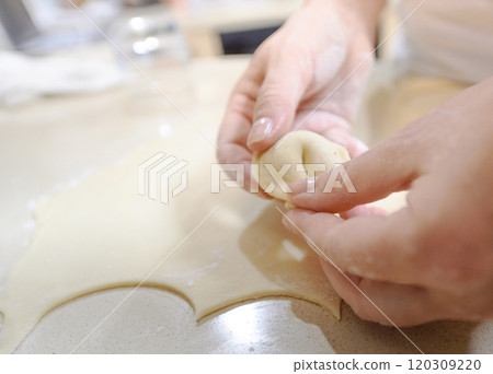 Making traditional dumplings by hand in a modern kitchen during a weekend cooking session 120309220
