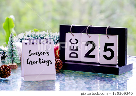 Seasons Greetings text text on white notepad with Christmas decoration background. Christmas celebration concept. 120309340