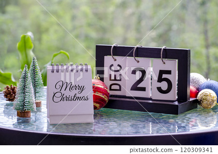 Merry Christmas text on white notepad with simple Christmas decoration background. Christmas celebration concept. 120309341