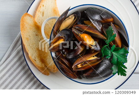 Fresh, Boiled mussels, Black Sea, with white bread, on a white wooden table, no people, Fresh, Boiled mussels, Black Sea, with white bread, on a white wooden table, no people, 120309349