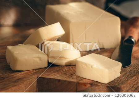 butter briquette, on wrapping paper, wooden chopping board and butter knife,breakfast, rustic style, no people, 120309362