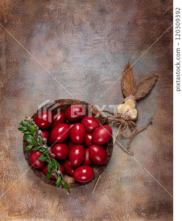 painted eggs in a wooden bowl, red, painted madder dye, powder from the roots of endro, with onion husks, top view, Easter, Georgia, 120309392
