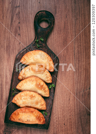 fried chebureks, deep-fried, mini, on a chopping board, wooden table, close-up, no people, 120309397