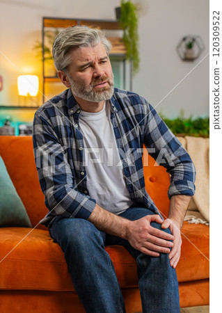 Middle-aged man suffer from painful severe knee joint ache, leg muscles illness cramps rheumatism 120309522
