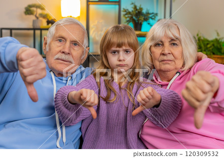 Child girl granddaughter with grandparents showing thumbs down disapproval dissatisfied dislike Child girl granddaughter with grandparents showing thumbs down disapproval dissatisfied dislike 120309532