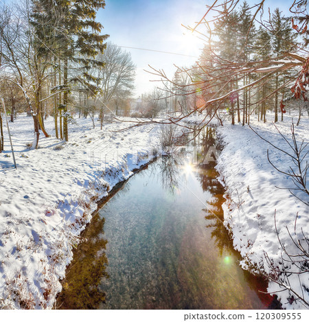 Colorful landscape with snowy trees, beautiful frozen river with reflection in water. 120309555