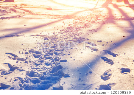 View of footprints in the snow during sunset View of footprints in the snow during sunset 120309589