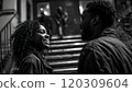 Black guy and girl are chatting cheerfully while two unknown people are coming down the stairs 120309604