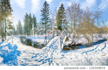 Fabulous landscape in city park with snowy trees and beautiful frozen river and footbridge Fabulous landscape in city park with snowy trees and beautiful frozen river and footbridge 120309635