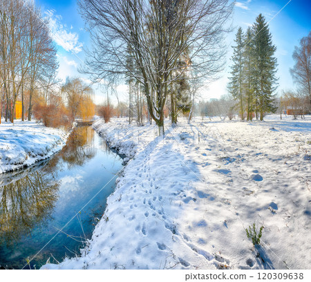 Colorful landscape with snowy trees, beautiful frozen river with reflection in water. 120309638
