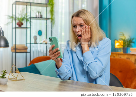 Businesswoman using smartphone loses receive email message bad news game fail loss at home office Businesswoman using smartphone loses receive email message bad news game fail loss at home office 120309755