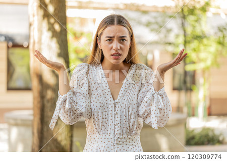 Confused young woman feeling embarrassed about ambiguous question having doubts no idea clueless Confused young woman feeling embarrassed about ambiguous question having doubts no idea clueless 120309774