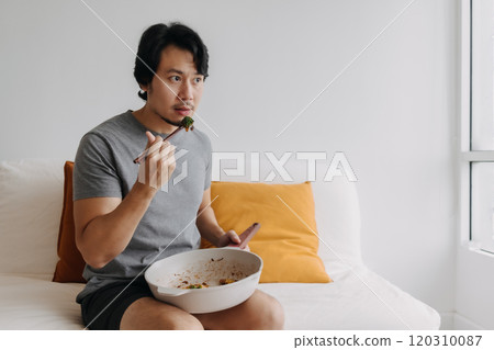 Man eating his homemade diet meal in the pan as it is his daily routine. Man eating his homemade diet meal in the pan as it is his daily routine. 120310087