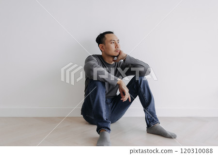 Lonely Freelance creative man sitting alone in empty white room. Lonely Freelance creative man sitting alone in empty white room. 120310088