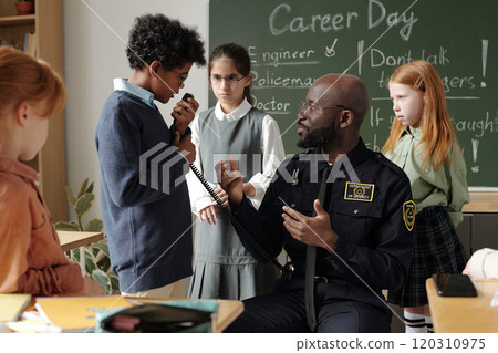 Schoolboy speaking in walkie-talkie 120310975