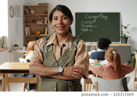 Happy young female teacher wearing dress Happy young female teacher wearing dress 120311004