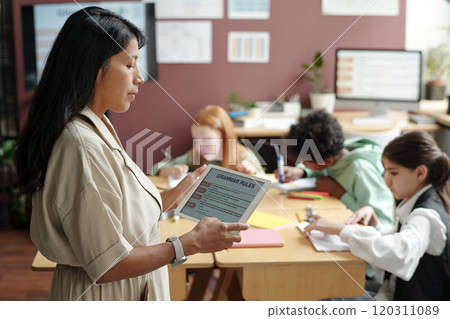 Teacher using tablet with grammar rules Teacher using tablet with grammar rules 120311089