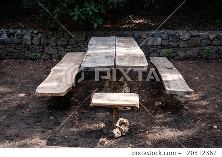 wooden table and bench in forest. Picnic spot on hiking trail 120312362