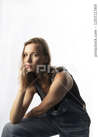 young woman in denim overalls, studio shooting 120312369