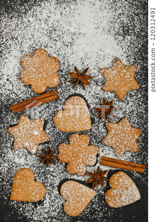 Gingerbread cookies and spices on black slate Gingerbread cookies and spices on black slate 120312491