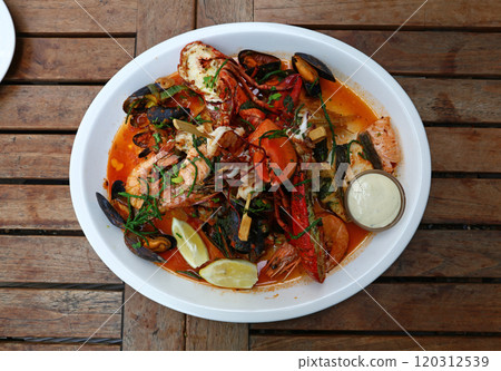 Grilled seafood platter on wooden table 120312539