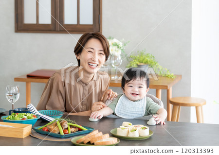 Mom and baby eating 120313393